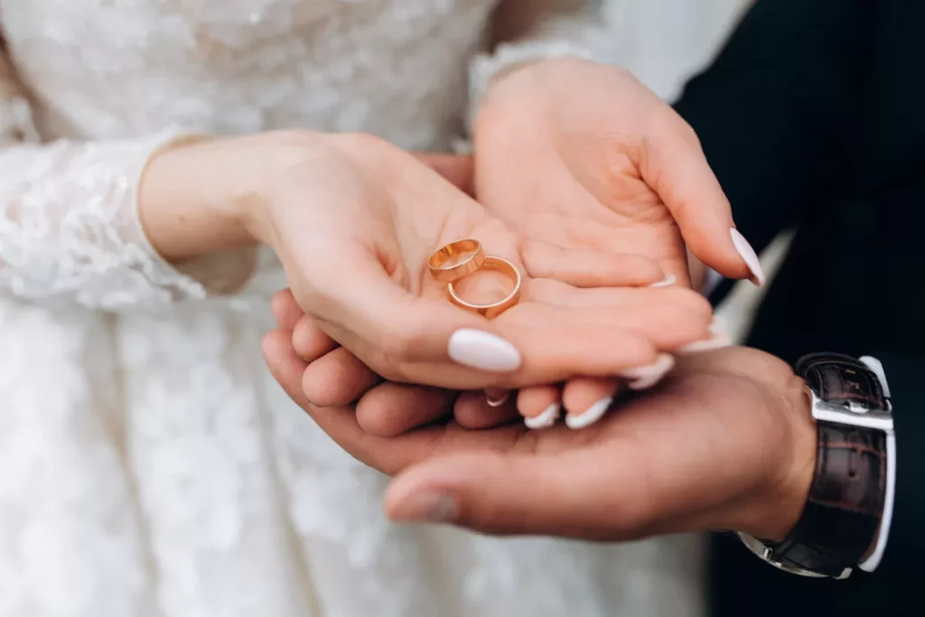 Couple holding wedding rings