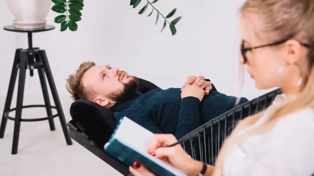 Psychologist writing down notes during therapy