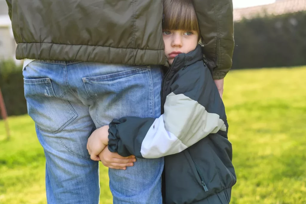 Kid holding adult's leg