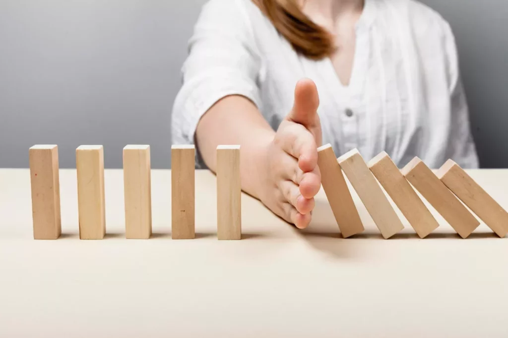 Woman stopping the wooden pieces of fall