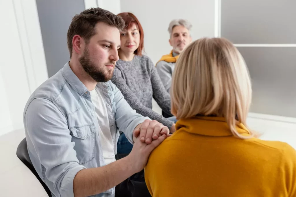 Man comforting woman at therapy