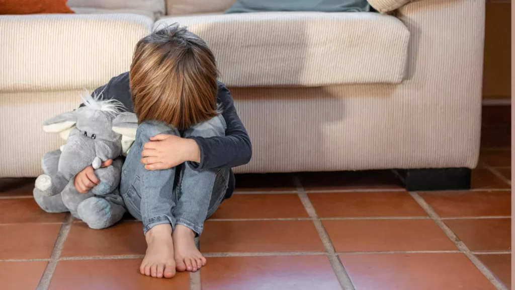 Little boy upset holding his toy