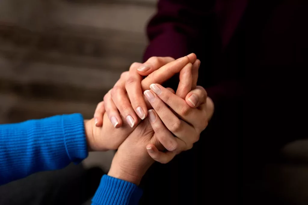 Hands holding each other for support