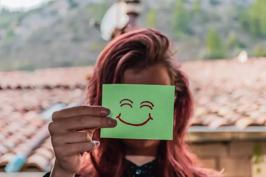 Woman holding smile shape paper