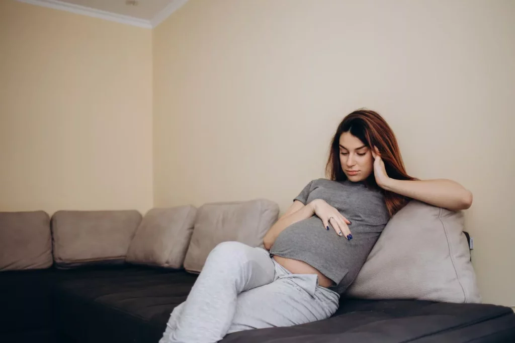 Pregnant woman sitting on a couch