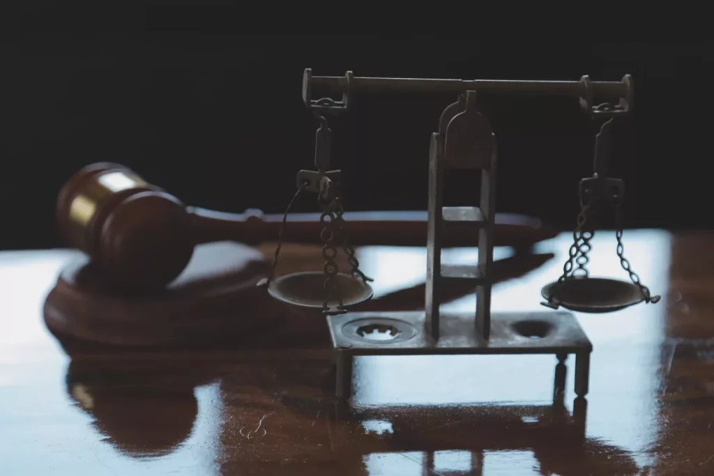 Law books and scales of justice on desk